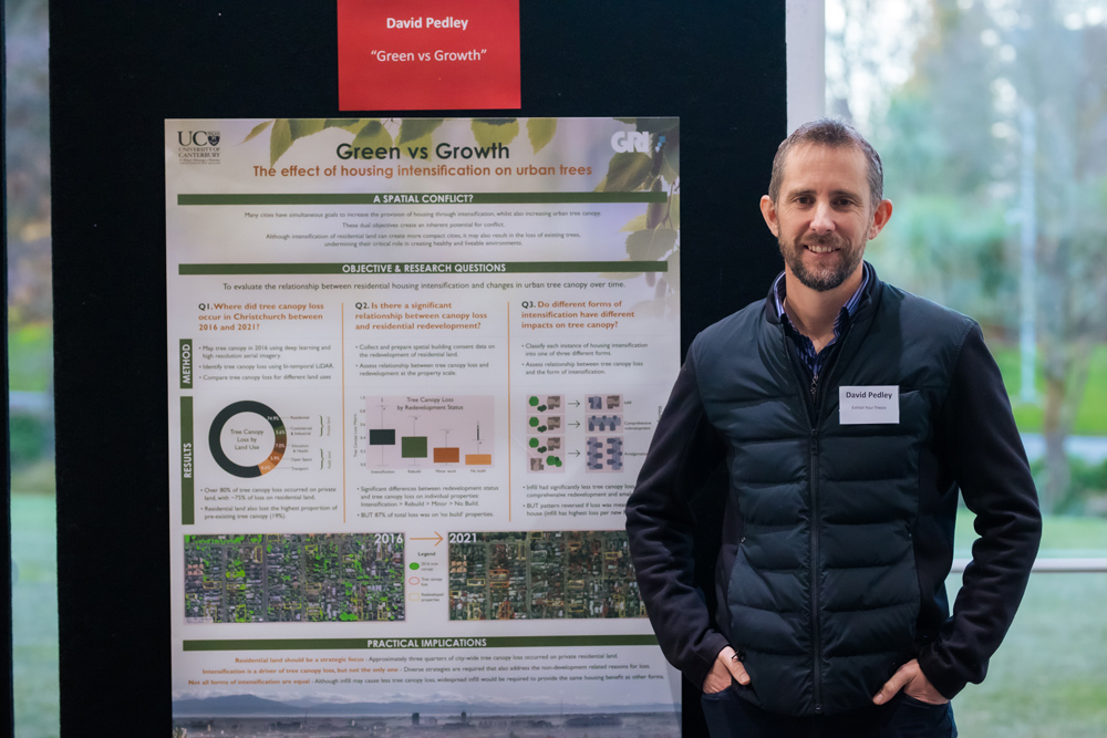 David Pedley standing in front of his poster